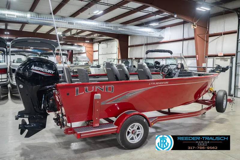 Slide: The Image of 2020 Lund 1775 Adventure SS boat in showroom, featuring Mercury outboard motor. - 6