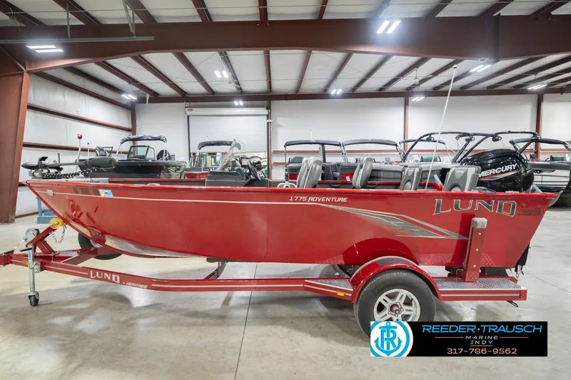 Slide: The Image of 2020 Lund 1775 Adventure SS boat in showroom, red exterior, on trailer. - 9
