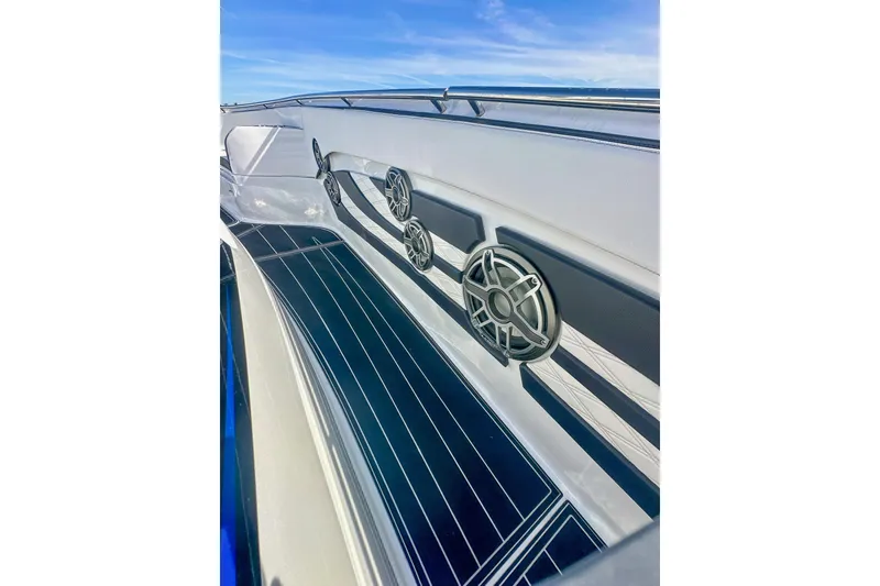 Slide: The Image of Luxury MTI V42 boat interior with modern seating, overlooking waterfront cityscape, 2024 model. - 10