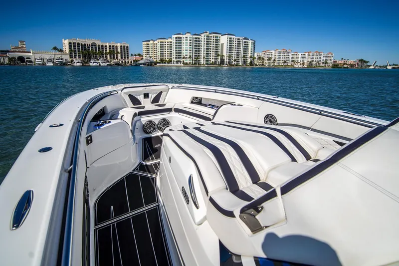 Slide: The Image of Luxurious 2024 MTI V42 boat interior with striped seating, docked near waterfront buildings. - 19