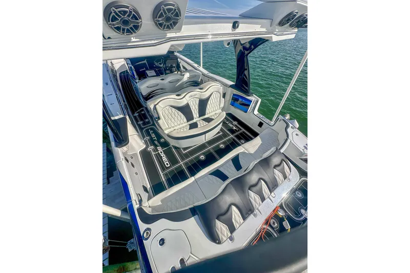 Slide: The Image of 2024 MTI V42 boat on water with luxury waterfront homes in the background. - 5