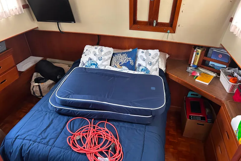 Slide: The Image of Cozy cabin interior of 1980 Grand Banks 42 Classic with bed, TV, and books. - 12