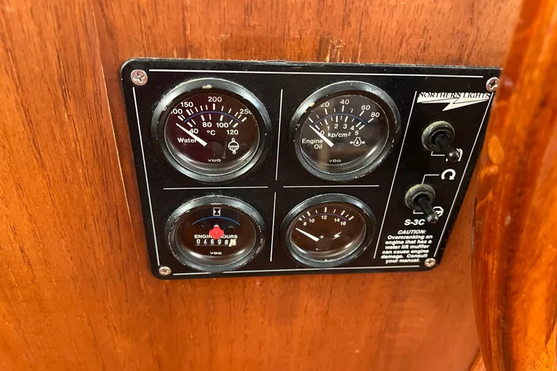 Slide: The Image of Instrument panel on 1980 Grand Banks 42 Classic boat, featuring gauges and switches. - 19