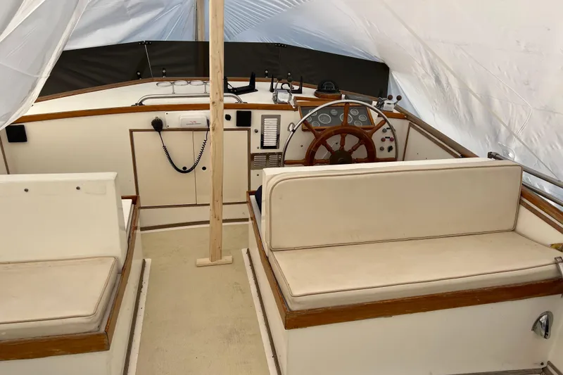 Slide: The Image of Interior view of 1980 Grand Banks 42 Classic yacht helm with wooden wheel and seating. - 21