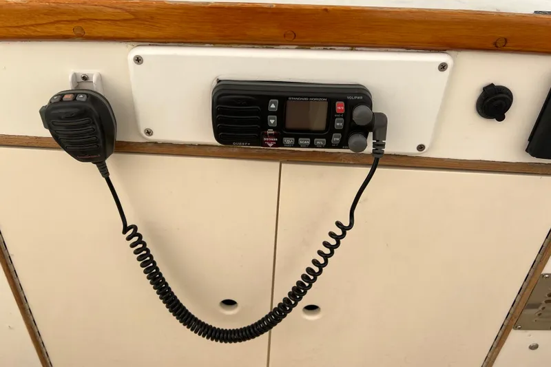 Slide: The Image of VHF radio system on 1980 Grand Banks 42 Classic boat, featuring a microphone and control panel. - 22
