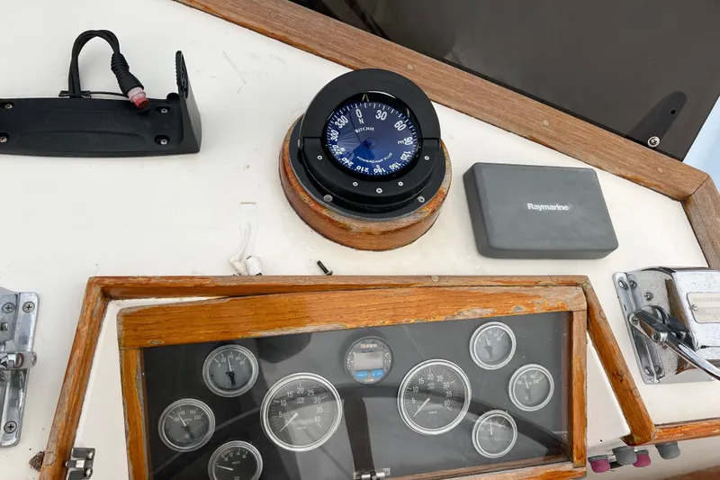 Slide: The Image of Helm of 1980 Grand Banks 42 Classic with compass and Raymarine equipment. - 24