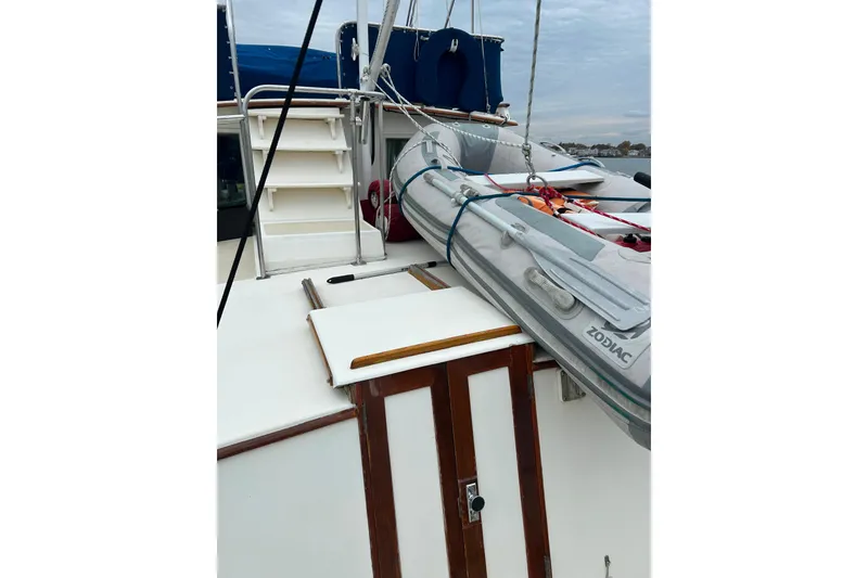 Slide: The Image of 1980 Grand Banks 42 Classic yacht deck with Zodiac inflatable boat. - 26