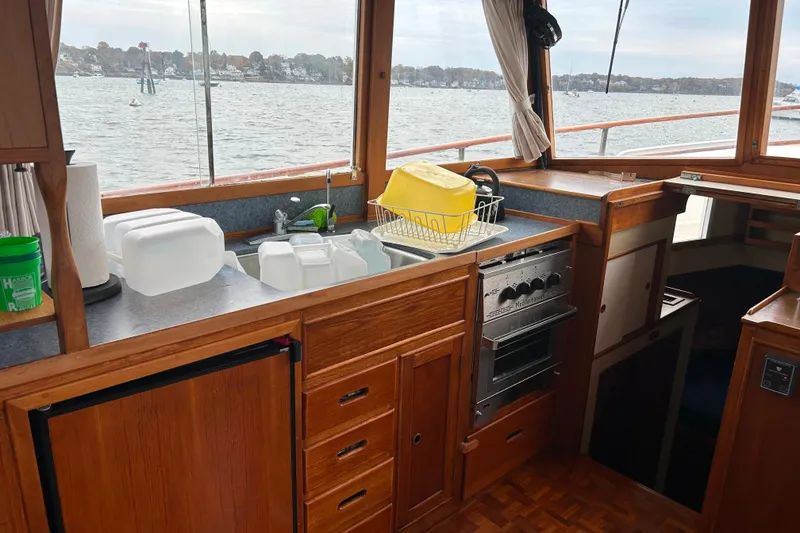 Slide: The Image of 1980 Grand Banks 42 Classic yacht kitchen with wooden cabinetry and ocean view. - 6