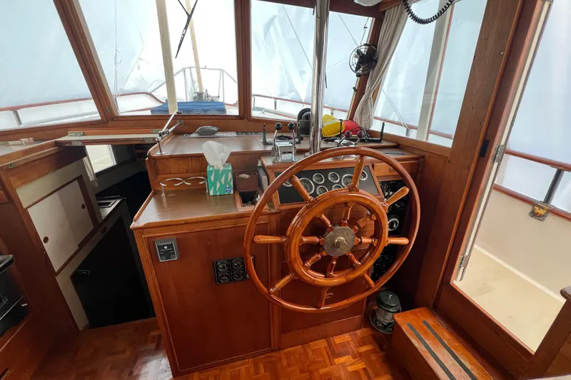Slide: The Image of 1980 Grand Banks 42 Classic helm with wooden wheel and vintage controls. - 7