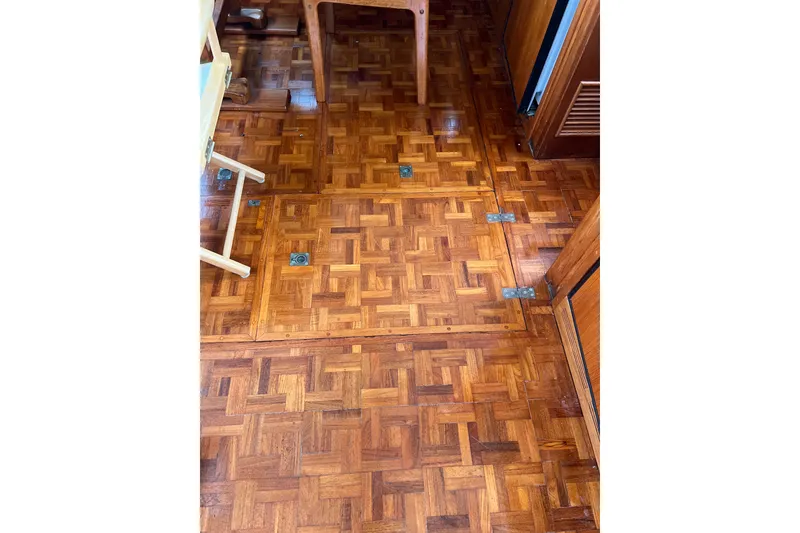 Slide: The Image of Wooden parquet flooring on a 1980 Grand Banks 42 Classic boat interior. - 9