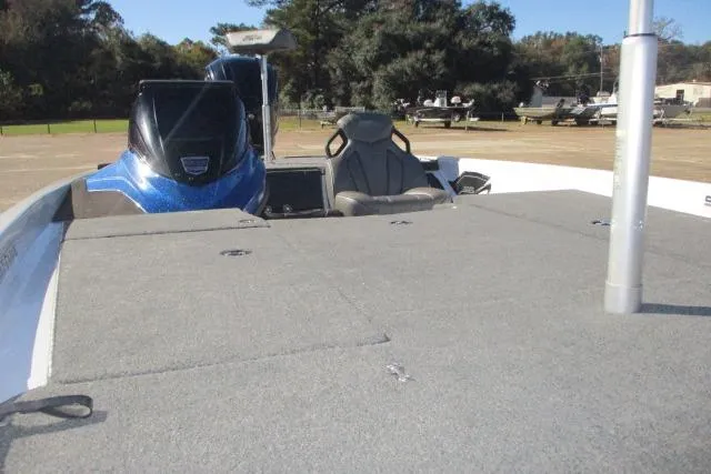 Slide: The Image of 2024 Skeeter ZXR19 boat interior with seating and deck, parked outdoors. - 5