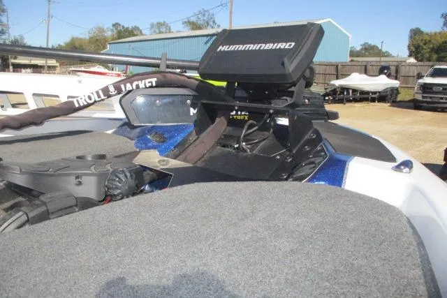 Slide: The Image of 2024 Skeeter ZXR19 boat with Humminbird fish finder and trolling motor, parked outdoors. - 6