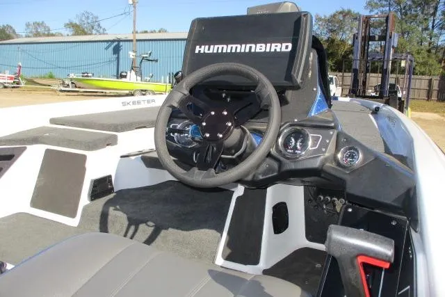 Slide: The Image of 2024 Skeeter ZXR19 boat dashboard with Humminbird electronics and steering wheel. - 7