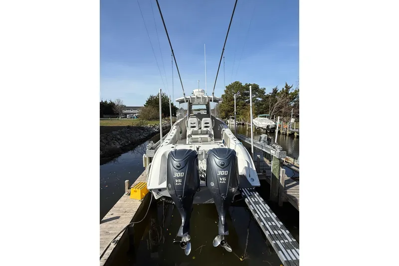 Slide: The Image of 2021 Cape Horn 32 XS boat with dual 300 V6 engines docked in a marina. - 10