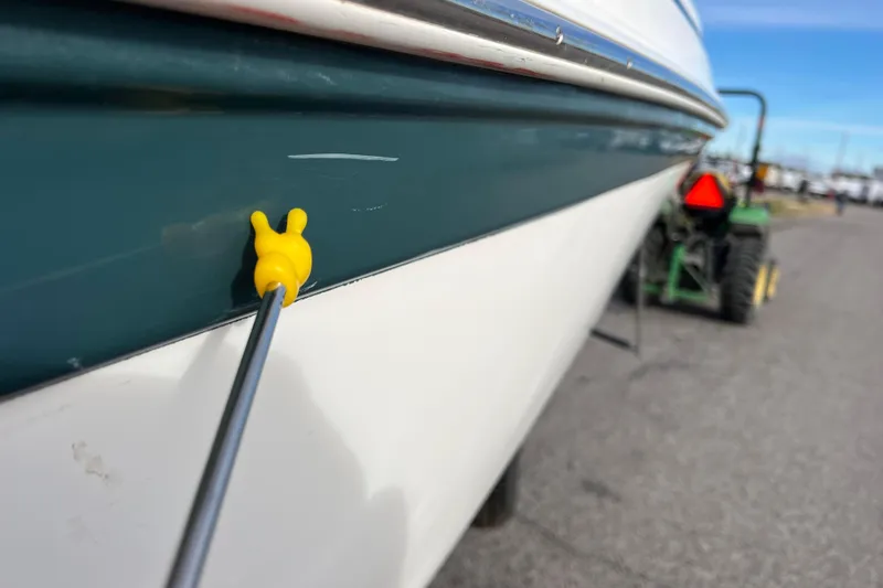 Slide: The Image of 2006 Hurricane FunDeck GS 194 OB boat with yellow plug on hull. - 12