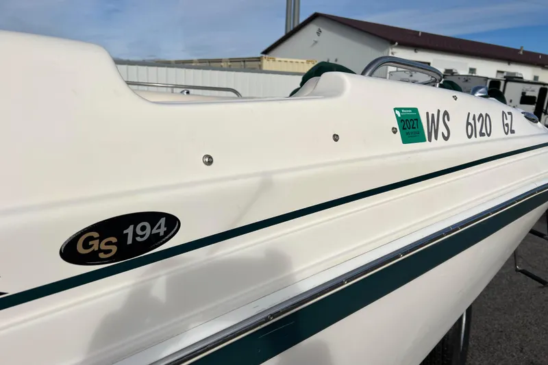 Slide: The Image of 2006 Hurricane FunDeck GS 194 OB boat with registration details, docked outdoors. - 14