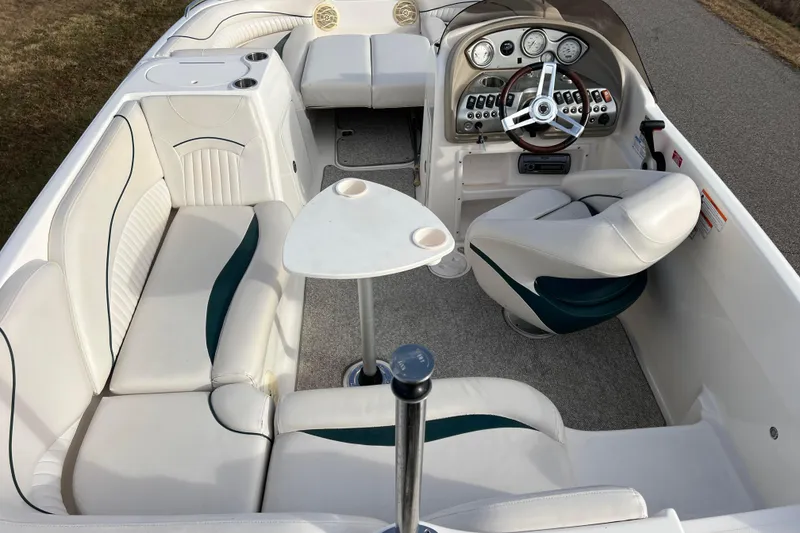 Slide: The Image of 2006 Hurricane FunDeck GS 194 OB boat interior with white seating and steering console. - 2