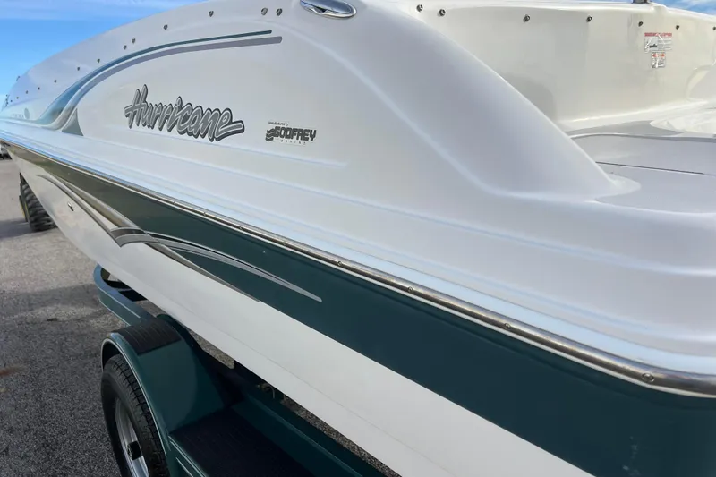 Slide: The Image of 2006 Hurricane FunDeck GS 194 OB boat, white and teal, on a trailer. - 21