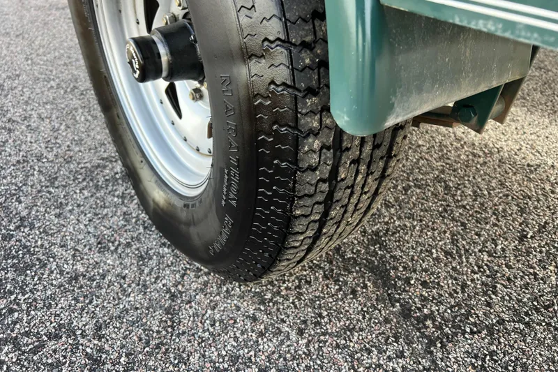 Slide: The Image of Close-up of a 2006 Hurricane FunDeck GS 194 OB trailer tire on asphalt. - 22