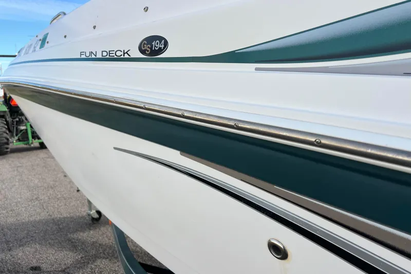 Slide: The Image of 2006 Hurricane FunDeck GS 194 OB boat, side view with sleek design and logo. - 23