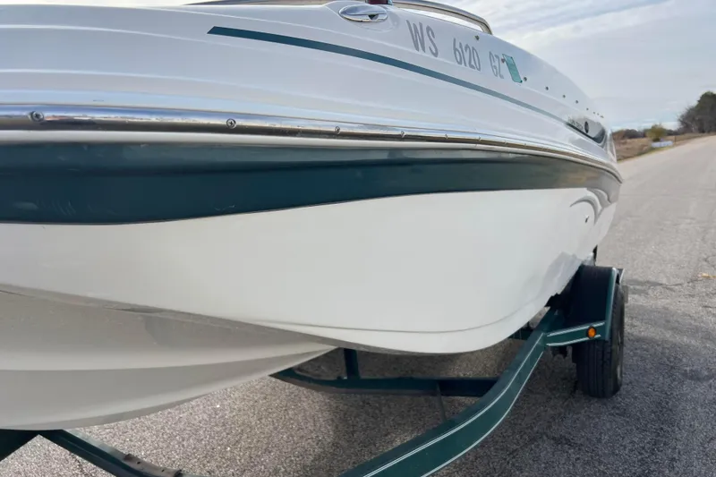 Slide: The Image of 2006 Hurricane FunDeck GS 194 OB boat on trailer, parked on a road. - 24