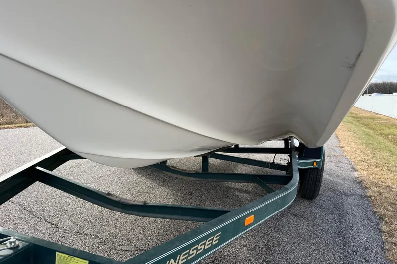 Slide: The Image of 2006 Hurricane FunDeck GS 194 OB boat on a trailer, parked on a road. - 25