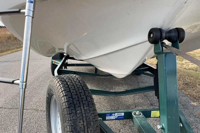 Slide: The Image of 2006 Hurricane FunDeck GS 194 OB boat on trailer, close-up view of hull and wheel. - 26