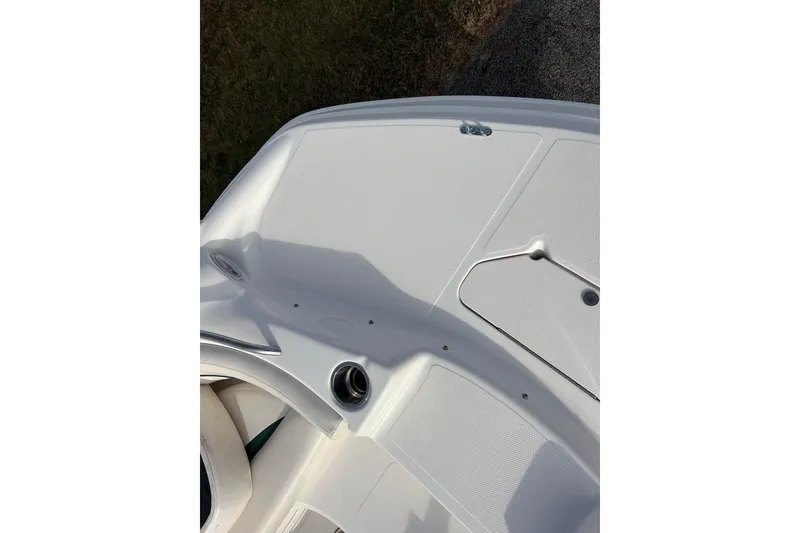 Slide: The Image of 2006 Hurricane FunDeck GS 194 OB boat deck, featuring clean white surface and storage compartments. - 30