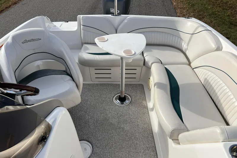 Slide: The Image of 2006 Hurricane FunDeck GS 194 OB boat interior with white seating and table. - 34