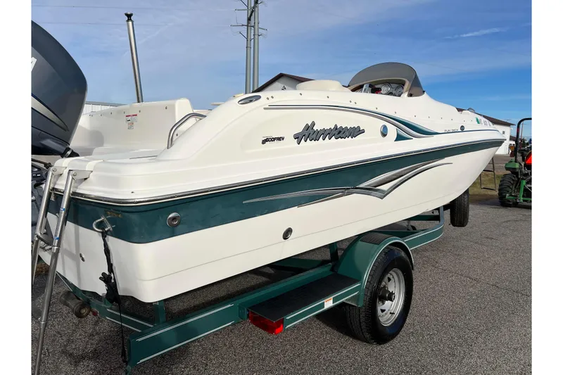 Slide: The Image of 2006 Hurricane FunDeck GS 194 OB boat on trailer, white and teal design. - 4