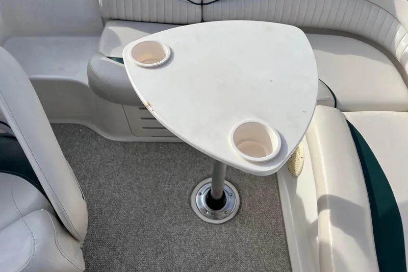 Slide: The Image of 2006 Hurricane FunDeck GS 194 OB boat interior with table and cup holders. - 43
