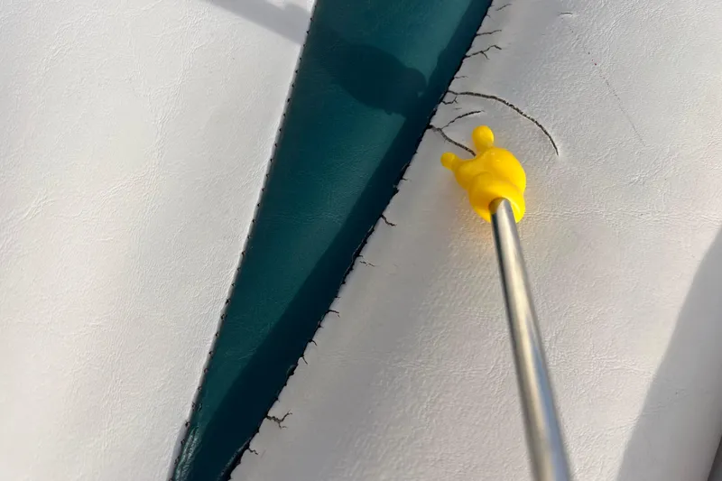 Slide: The Image of Cracked upholstery on 2006 Hurricane FunDeck GS 194 OB boat seat with yellow pointer. - 47