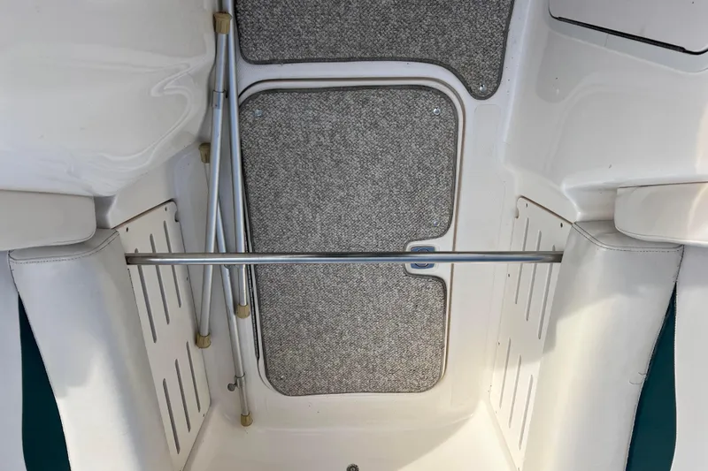 Slide: The Image of 2006 Hurricane FunDeck GS 194 OB interior with carpeted floor and metal support bars. - 58