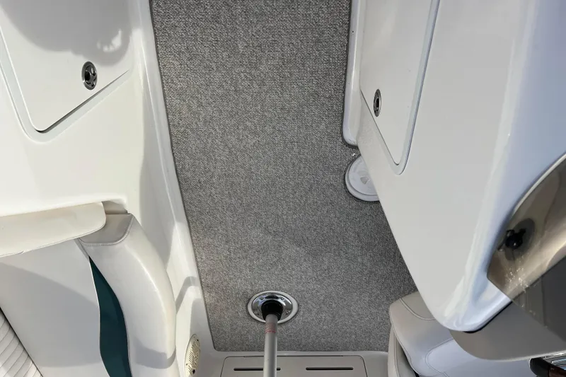 Slide: The Image of 2006 Hurricane FunDeck GS 194 OB interior with carpeted floor and storage compartments. - 59