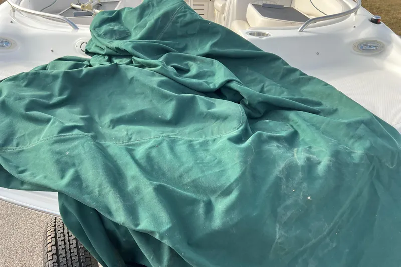 Slide: The Image of 2006 Hurricane FunDeck GS 194 OB boat with green cover on deck. - 62