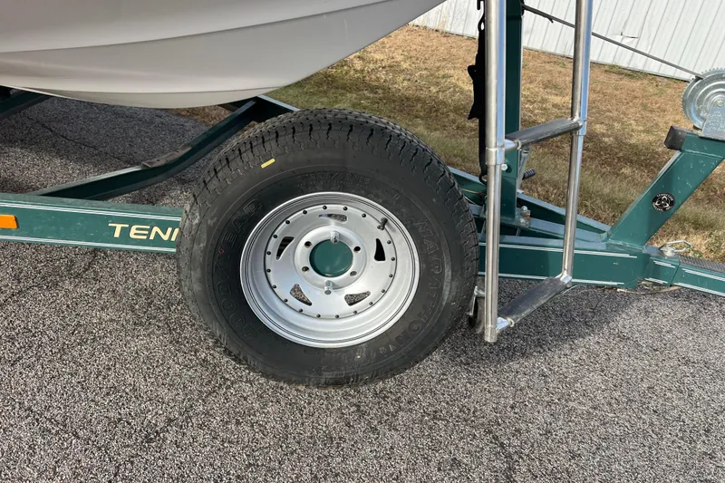Slide: The Image of Trailer wheel of a 2006 Hurricane FunDeck GS 194 OB boat on pavement. - 9