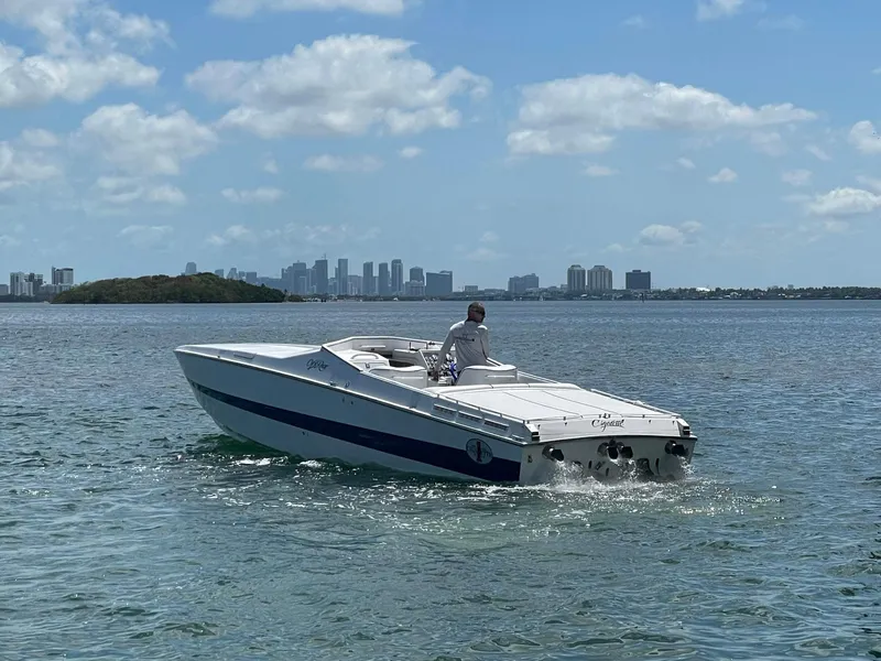 Slide: The Image of 1992 Cigarette 35 Cafe Racer speedboat cruising on a sunny day with city skyline in the background. - 3
