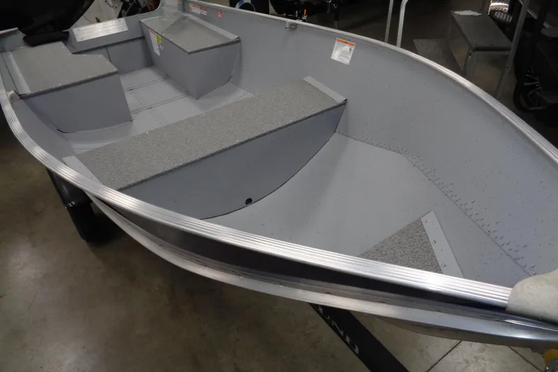 Slide: The Image of 2026 Lund WC-12 aluminum boat interior with seating and storage compartments. - 5