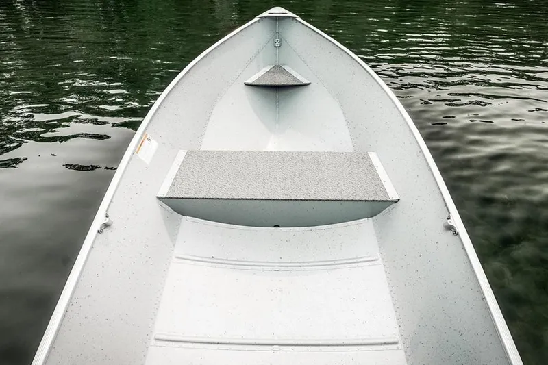 Slide: The Image of Manufacturer Provided Image: 2026 Lund WC-12 boat interior on calm water, showcasing seating and design. - 7