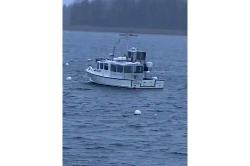 Slide: The Image of Calvin Beal COI PASSENGER boat from 2000 on a calm lake with buoys. - 0
