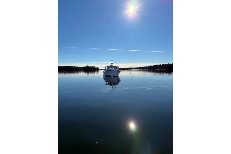 Slide: The Image of Calvin Beal COI PASSENGER boat on calm water under bright sun, 2000 model. - 1