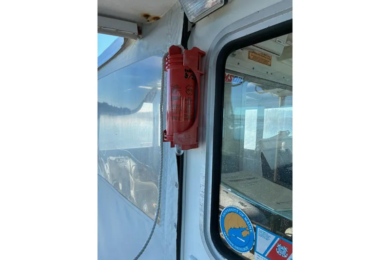 Slide: The Image of Calvin Beal COI PASSENGER 2000 boat with safety equipment and University of Maine sticker. - 10