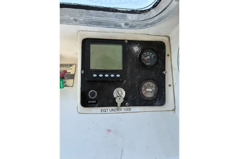 Slide: The Image of Control panel of a 2000 Calvin Beal COI PASSENGER boat with gauges and key. - 25