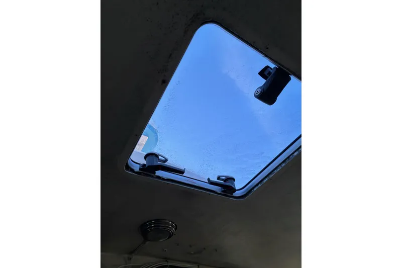 Slide: The Image of Open hatch view on 2000 Calvin Beal COI PASSENGER boat, showing clear blue sky. - 38