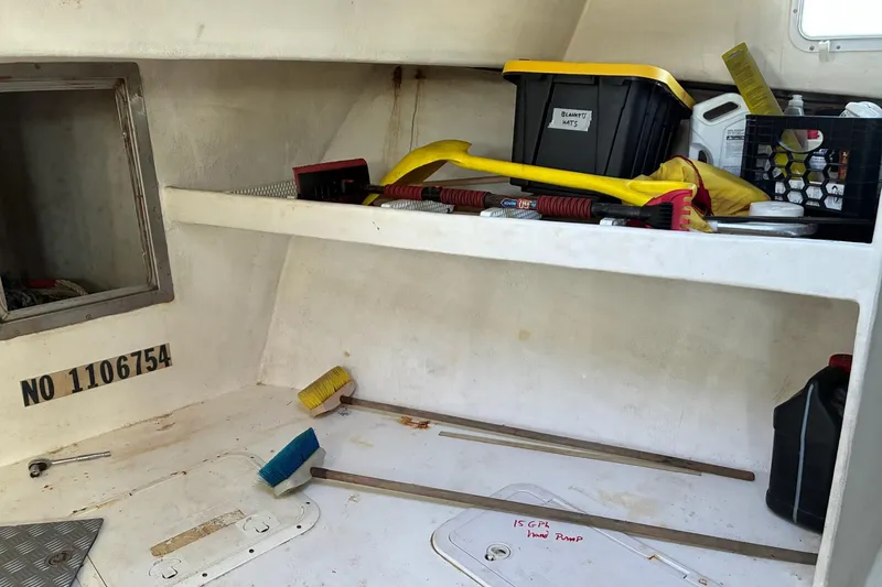 Slide: The Image of Interior of a 2000 Calvin Beal COI PASSENGER boat with storage and cleaning tools. - 39