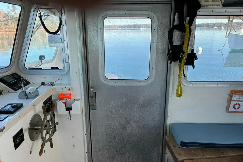 Slide: The Image of Interior of a 2000 Calvin Beal COI Passenger boat with steering wheel and safety equipment. - 50