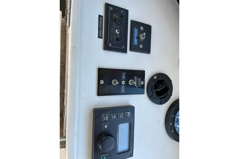 Slide: The Image of Control panel of a 2000 Calvin Beal COI PASSENGER boat with switches and dials. - 61