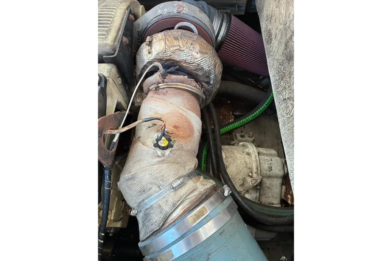 Slide: The Image of Engine compartment of a 2000 Calvin Beal COI PASSENGER boat, showing wrapped exhaust components. - 73