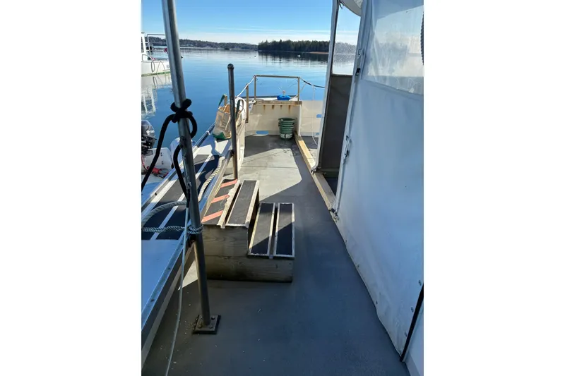 Slide: The Image of Calvin Beal COI PASSENGER boat deck, 2000 model, with steps and scenic water view. - 8