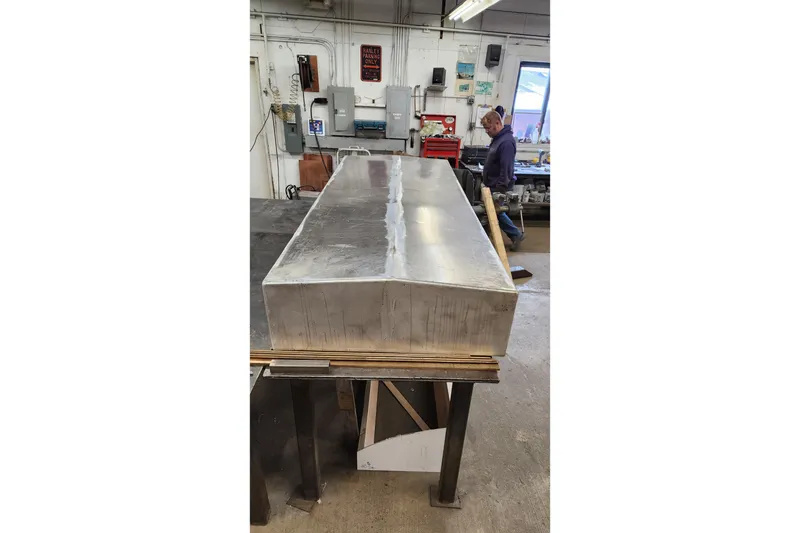 Slide: The Image of Workshop scene with a large metal box, Calvin Beal COI PASSENGER 2000 model. - 80